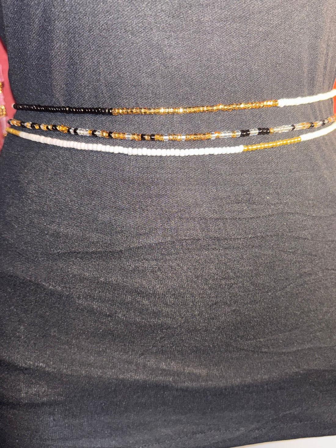 Handcrafted layered waist beads stacked on a natural waist