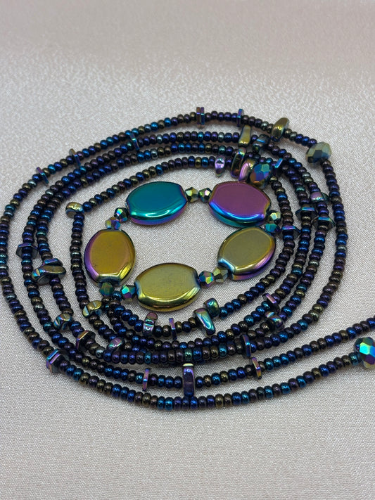 Oil Slick handcrafted waist beads featuring iridescent metallic rainbow focal stones and dark shimmering glass seed beads by Beadiful Adornments.